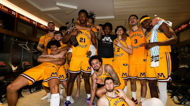 Minnesota poses for a team photo in the locker room after beating Rutgers on Sunday, Feb. 18, 2024.